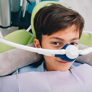 Child wearing a nasal mask at the dentist’s office