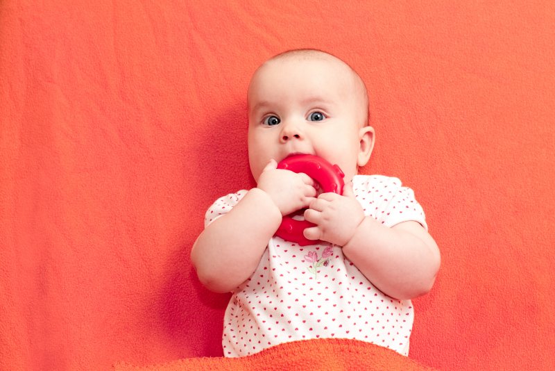 baby chewing on teething ring