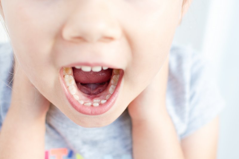 child with a shark tooth